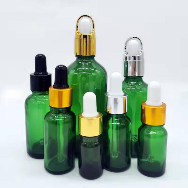 Green essential oil glass bottle