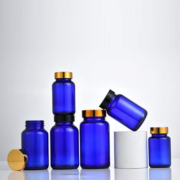 Blue wide mouth glass pill bottles